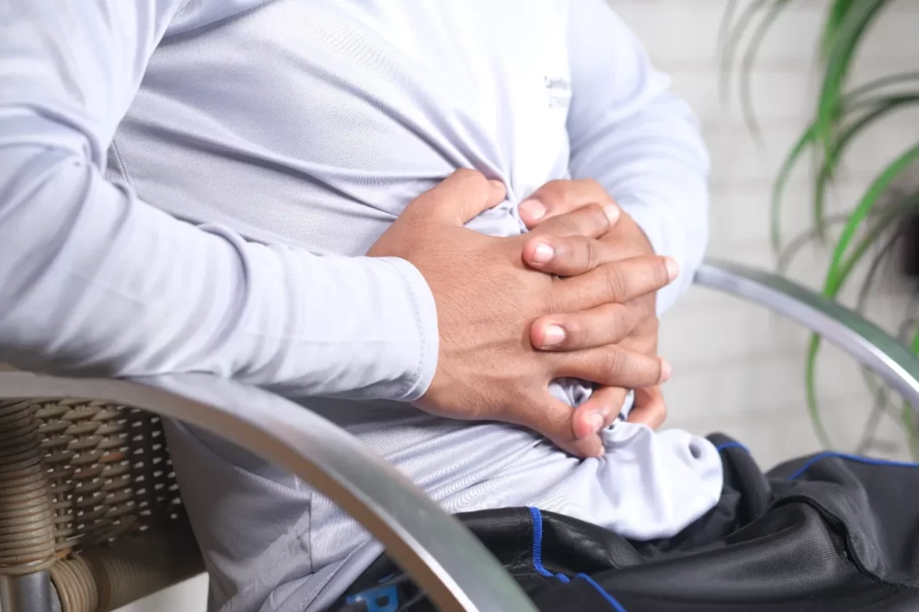 young man suffering stomach pain close up utc