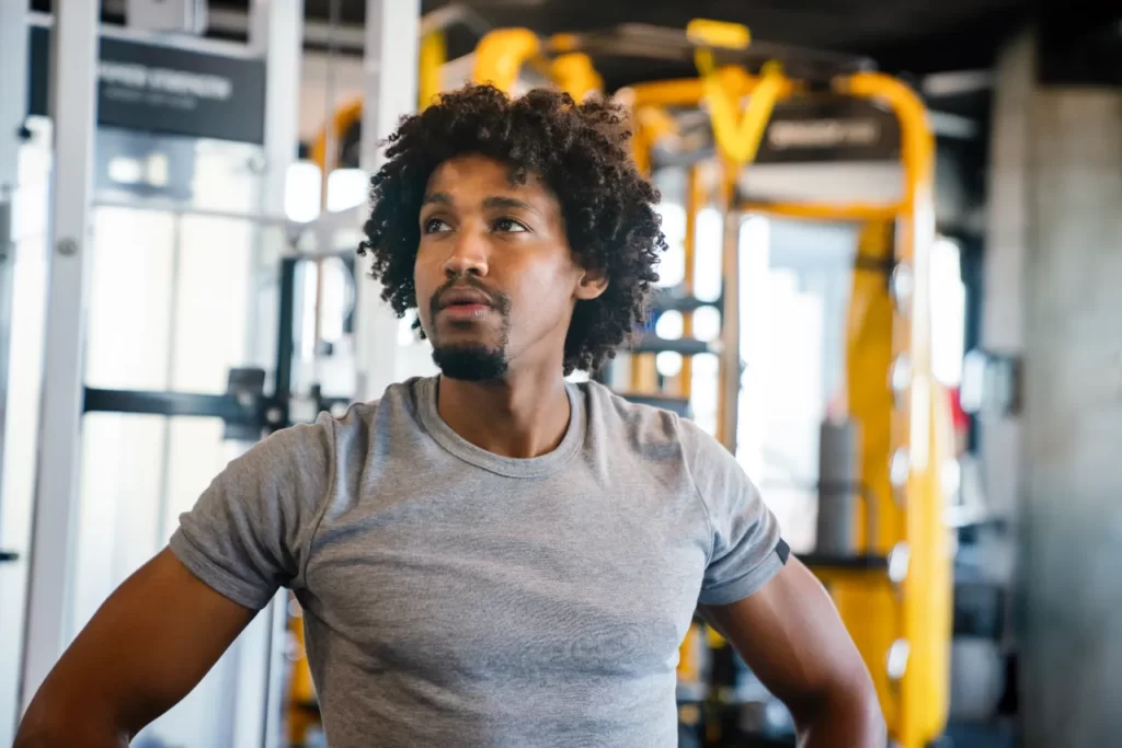 young muscular man during workout in the gym utc